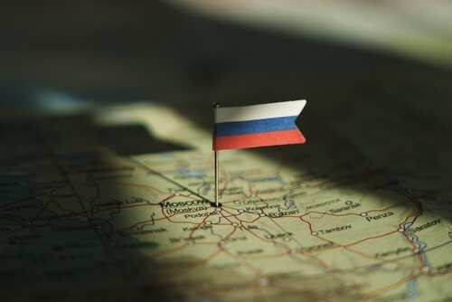 shutterstock_2533443209.jpg A small Russian flag pinned on a map