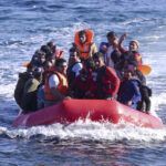 Biden Border Chaos, Migrants Land Where Nobody Expected A group of people in a red inflatable boat on the ocean