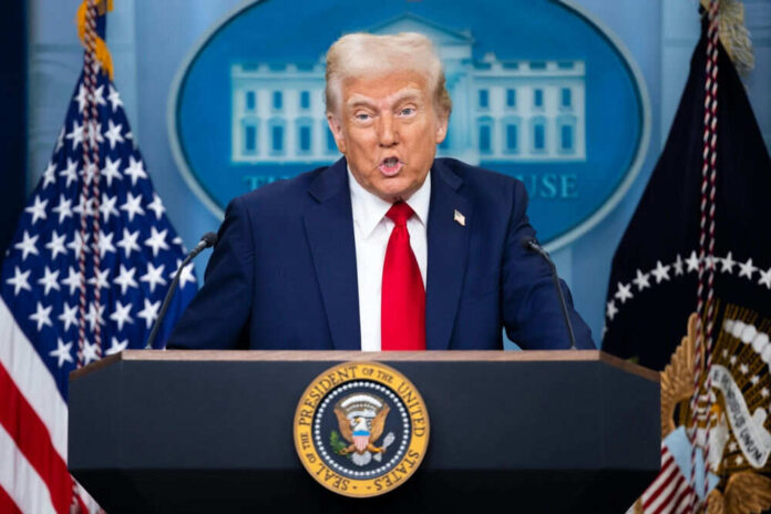 2591233787 Person speaking at a podium with flags behind