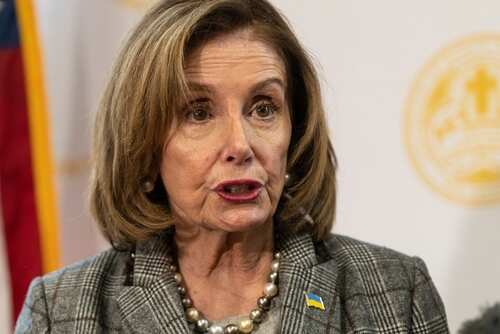 shutterstock_2135602015.jpg Nancy Pelosi speaking at a press event with a Ukrainian flag pin