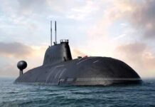 A submarine partially submerged in the ocean under a cloudy sky