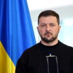 Zelensky’s Call to Dismantle Russian Leadership Marks Turning Point in War Strategy A political leader standing in front of a Ukrainian flag during a press conference