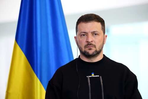 shutterstock_2333850047.jpg A political leader standing in front of a Ukrainian flag during a press conference