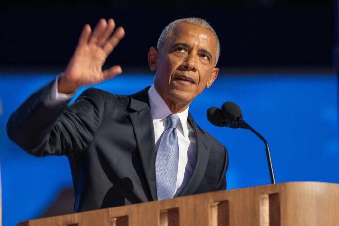shutterstock_2507620047.jpg A man in a suit delivering a speech at a podium