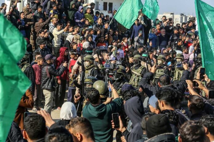 Large crowd with green flags and military personnel in a public demonstration