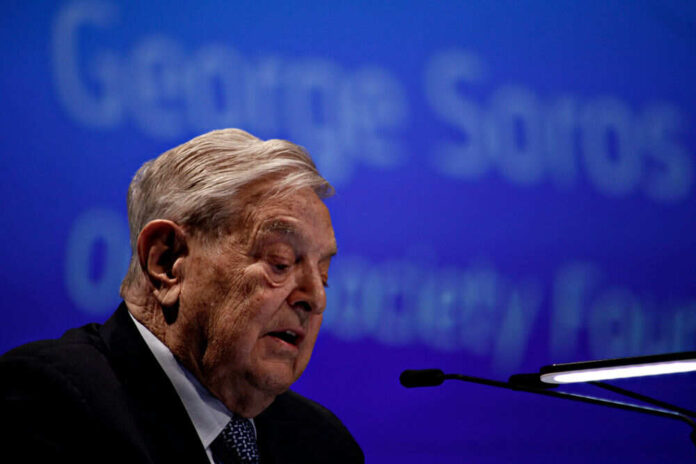 Elderly man speaking at a conference with microphone