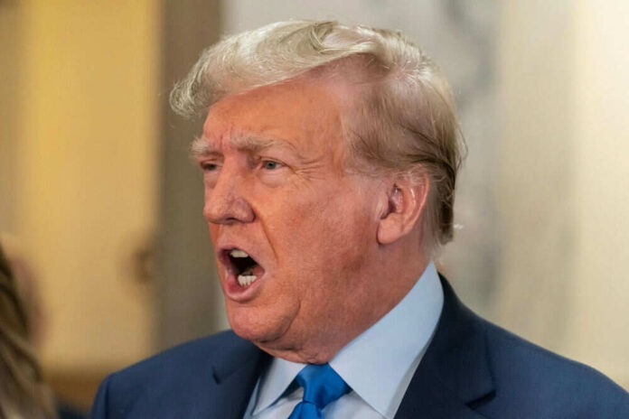 Man speaking with mouth open in a suit
