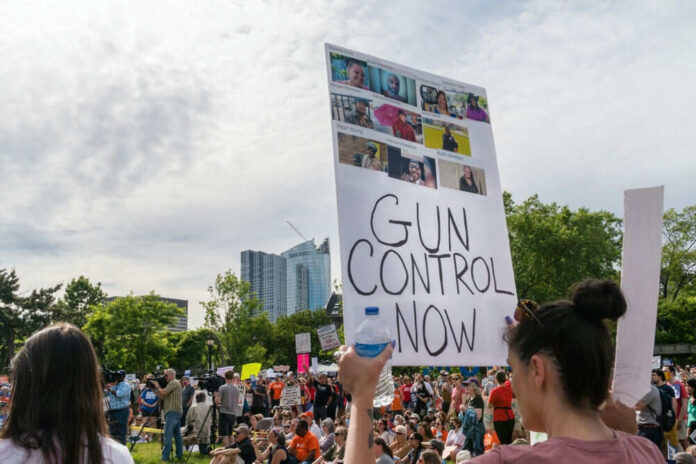 Protest with signs advocating for gun control policy