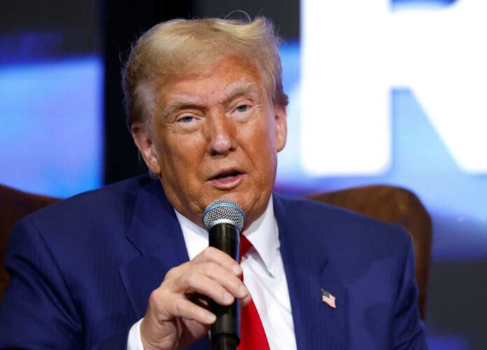 Man in blue suit holding a microphone