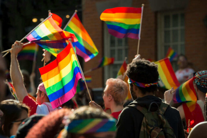 People holding rainbow flags at a pride parade