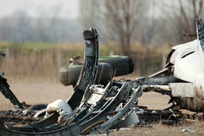 Wreckage of a crashed aircraft on barren field