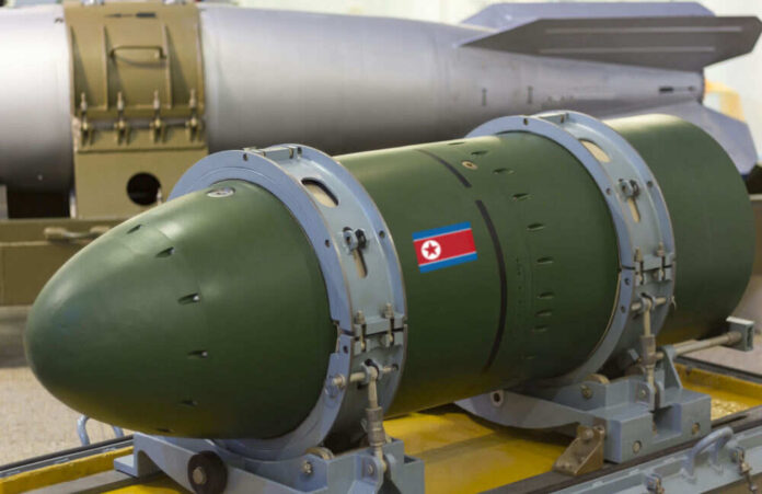 Green missile with North Korean flag in factory