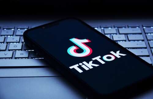 Smartphone displaying the TikTok logo on a keyboard