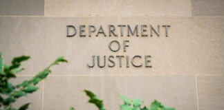Department of Justice sign on building wall