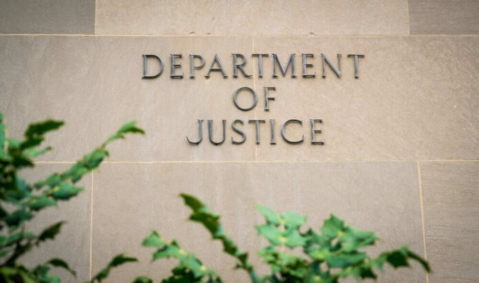 Department of Justice sign on building wall