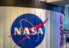 NASA’s Hidden Hand Shaping Moon Missions NASA logo on a curved wall display