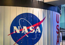 NASA’s Hidden Hand Shaping Moon Missions NASA logo on a curved wall display