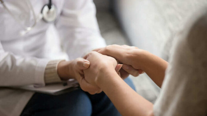 Doctor holding patients hands comforting them